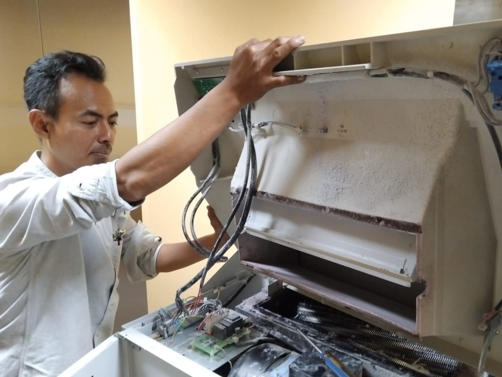 Teknisi sedang memperbaiki perangkat elektronik